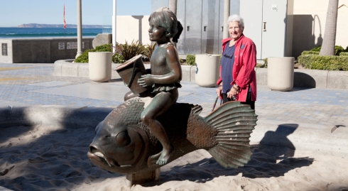 Mother posing with part of a bronze sculpture at Imperial Beach